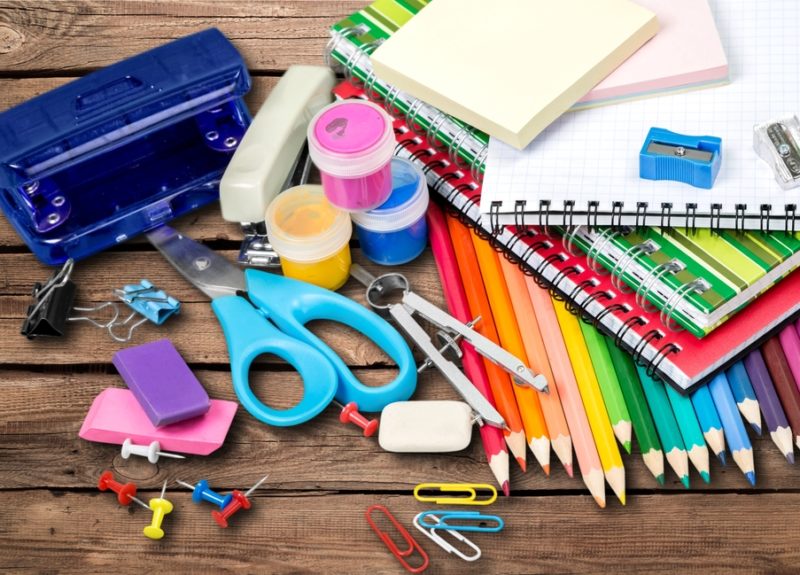 desk with crayons and school supplies strewn about